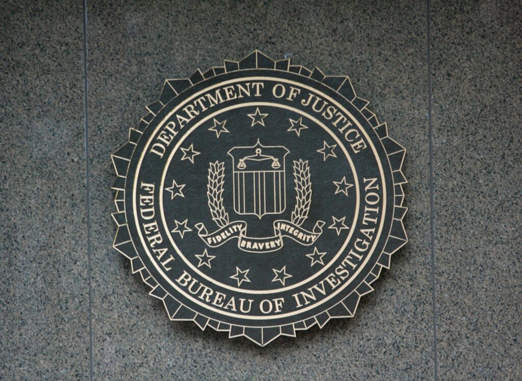 the seal of the department of justice and FBI on a wall