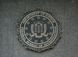 the seal of the department of justice and FBI on a wall